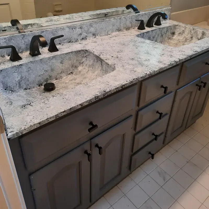 Cabinet painting project showing refinished bathroom cabinets with smooth painted surfaces, updated hardware, and clean interior finish detail.