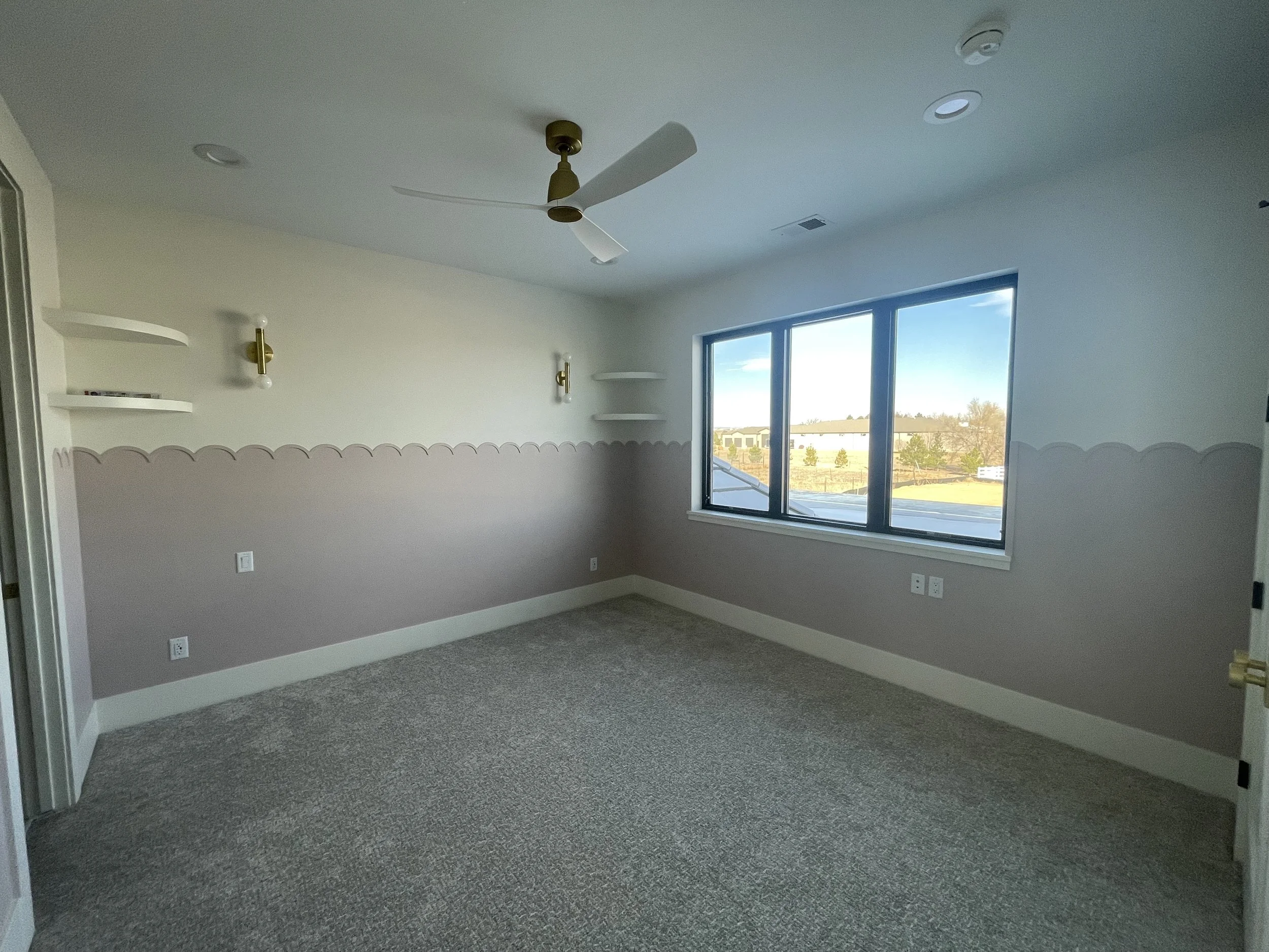 Professionally painted bedroom interior with custom two-tone wall design, soft neutral colors, modern lighting, and detailed finish work in contemporary Colorado home.
