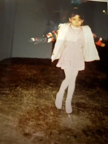 Young girl ice skating in handmade ice skating dress.