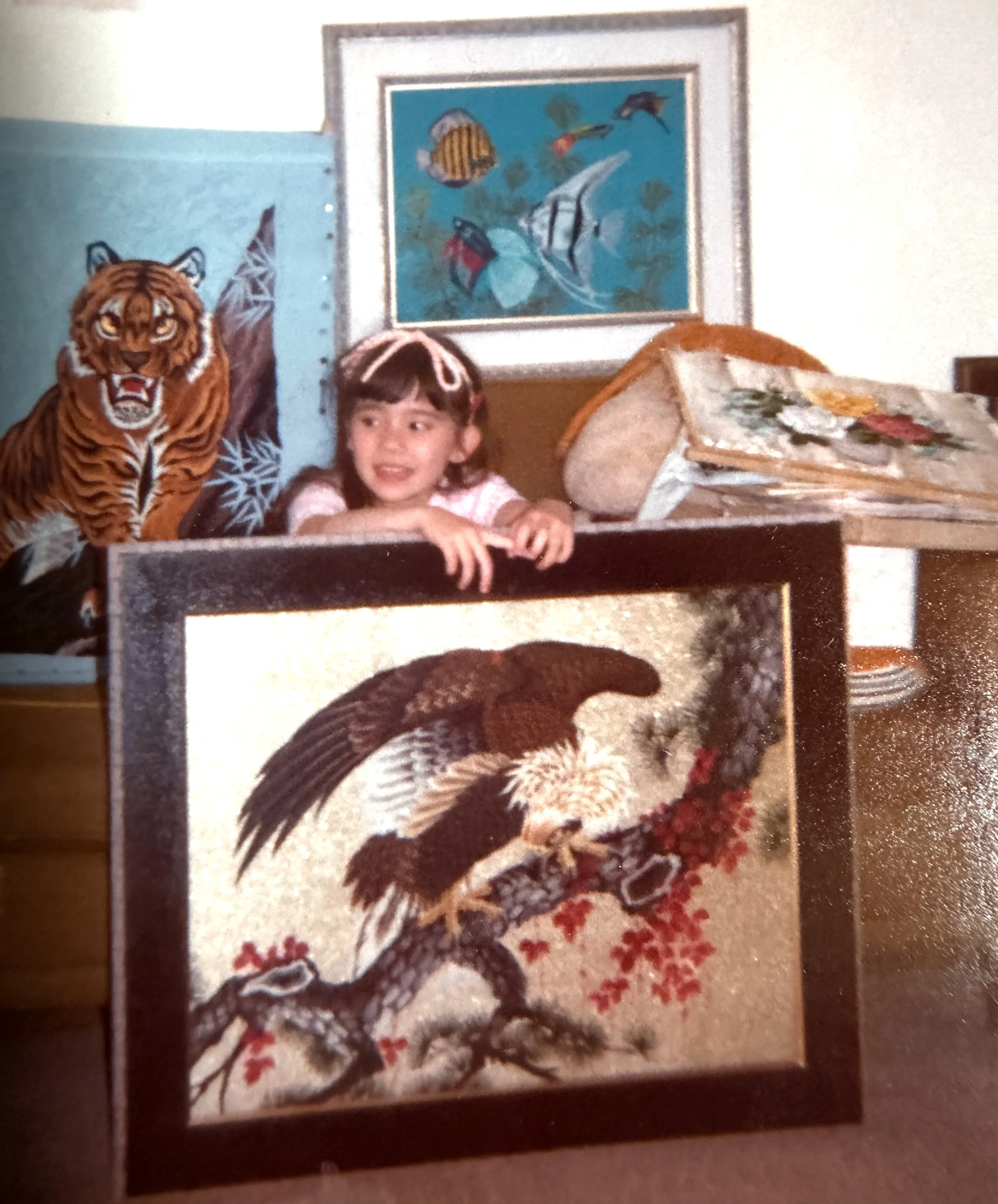 Young girl with Japanese needlepoint artwork