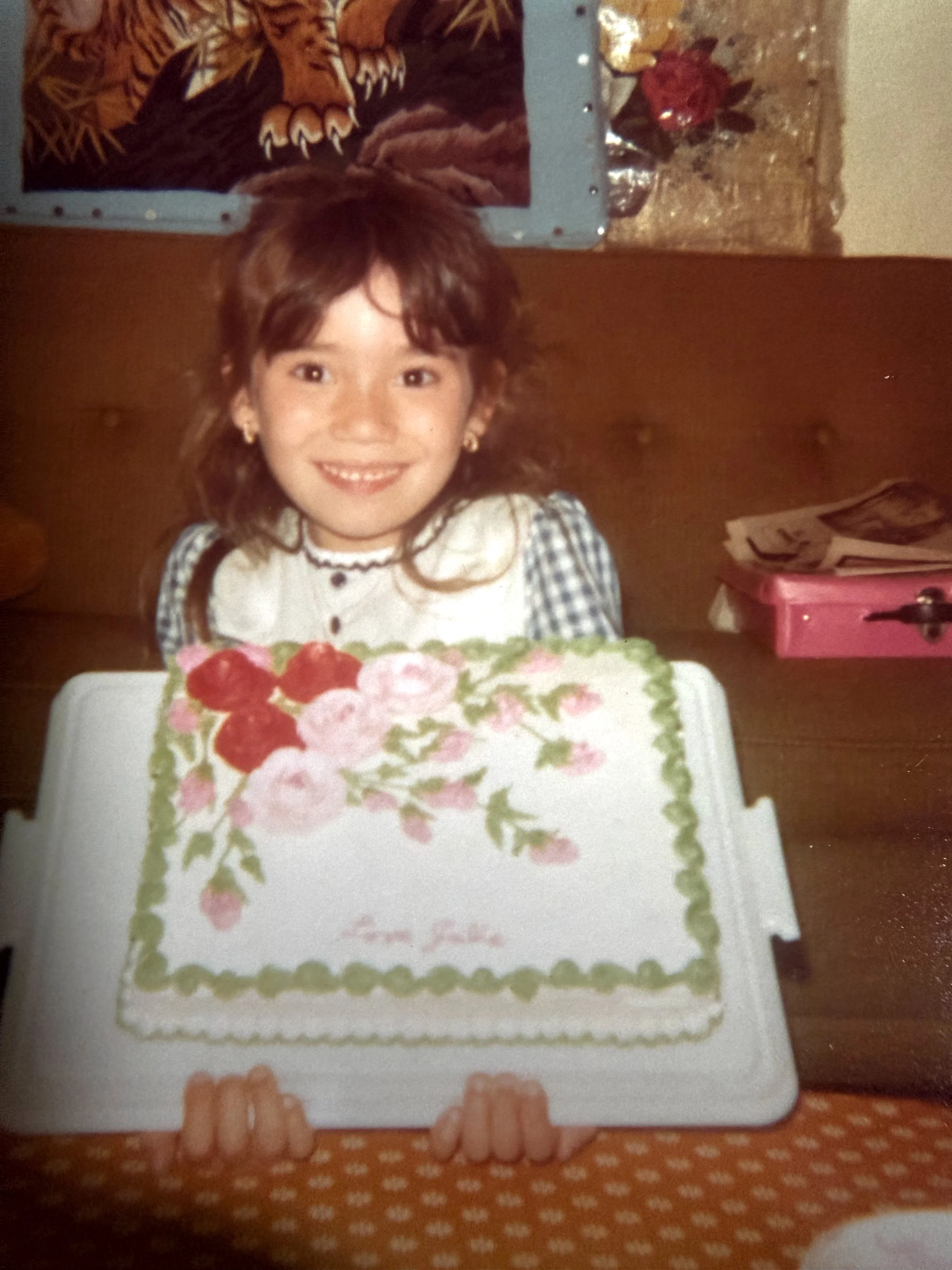 Young girl with beautifully decorated birthday cake