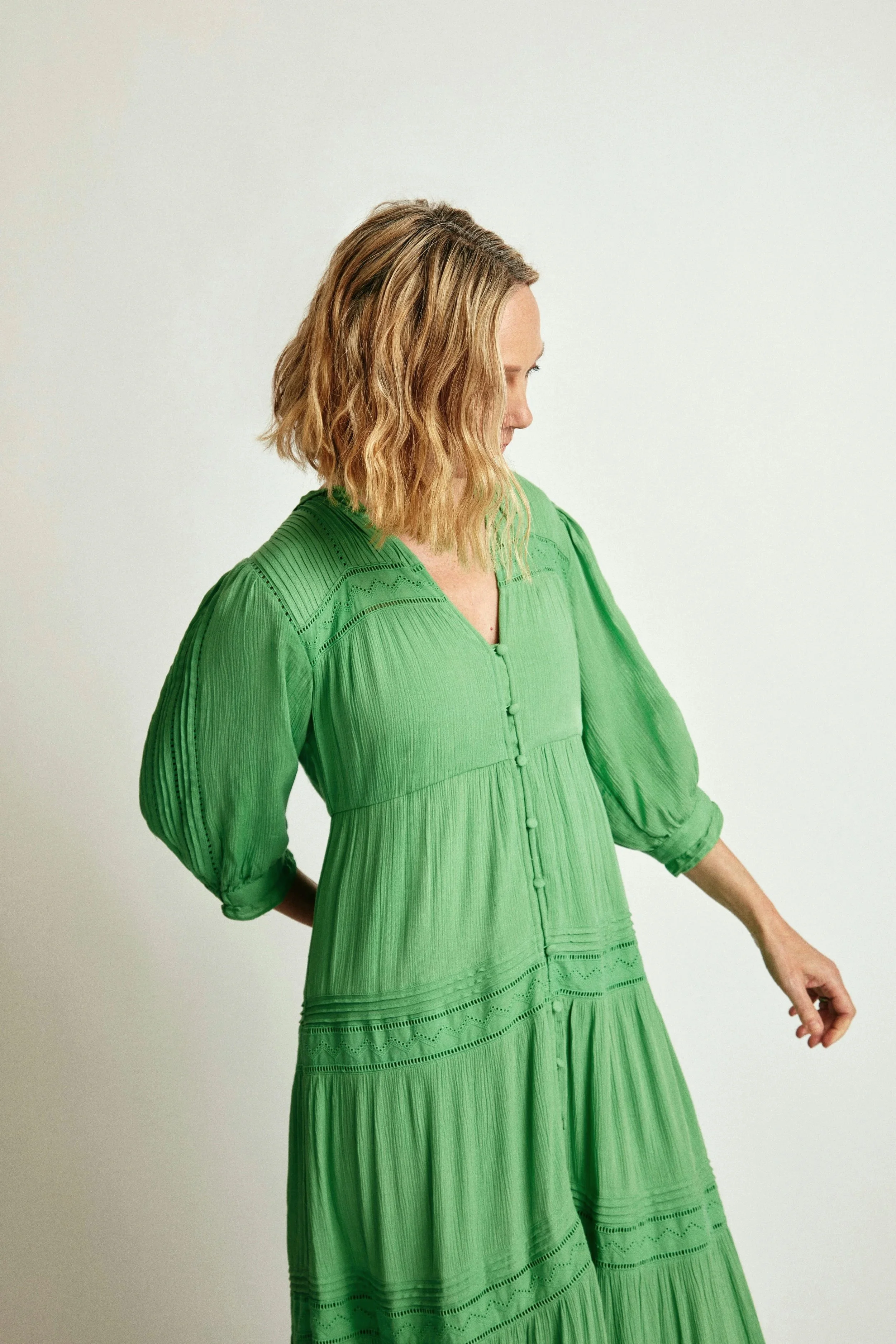 Woman wearing a green dress, looking to the side. Arcadia Women’s Wellness Gynecology & Preventive Care - Phoenix Arizona