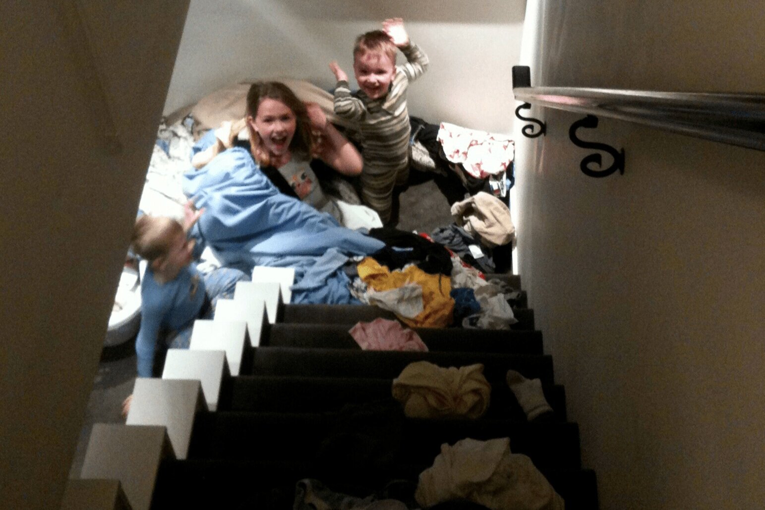 Emma, Jackson, and Coleton “helping” with laundry, in their adorable way.