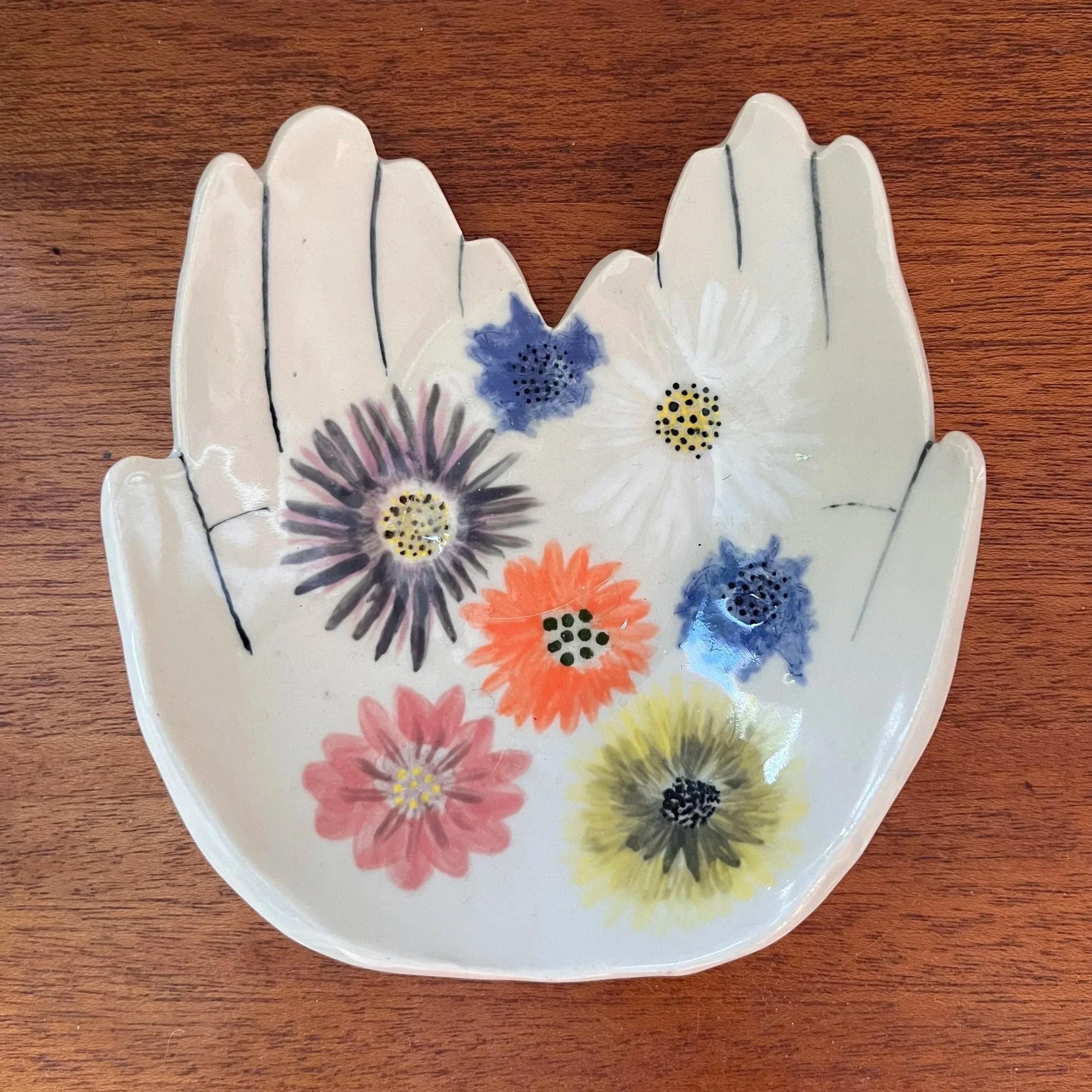 ceramic dish hands holding flowers