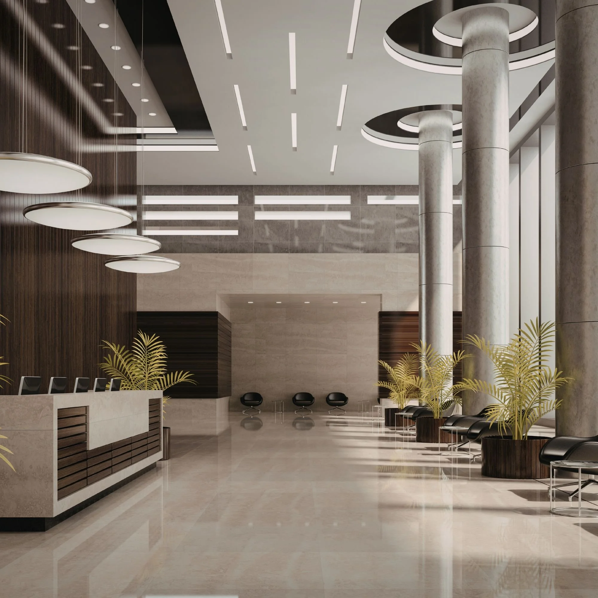 Modern lobby with polished marble floors, wooden wall accents, large circular hanging lights, tall marble columns, and black chairs arranged in a waiting area.