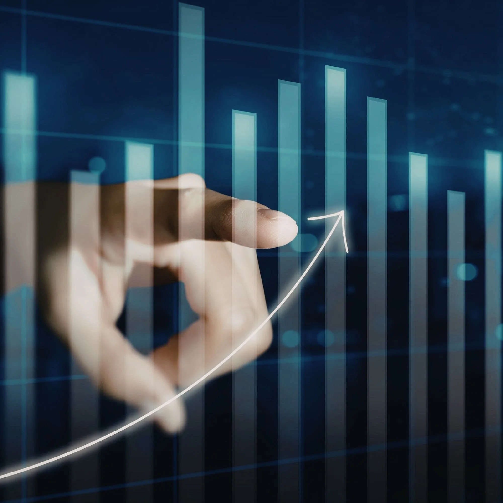 Close-up of a hand pointing at a digital financial chart showing an upward trend with bar graphs and a line graph on a transparent screen.
