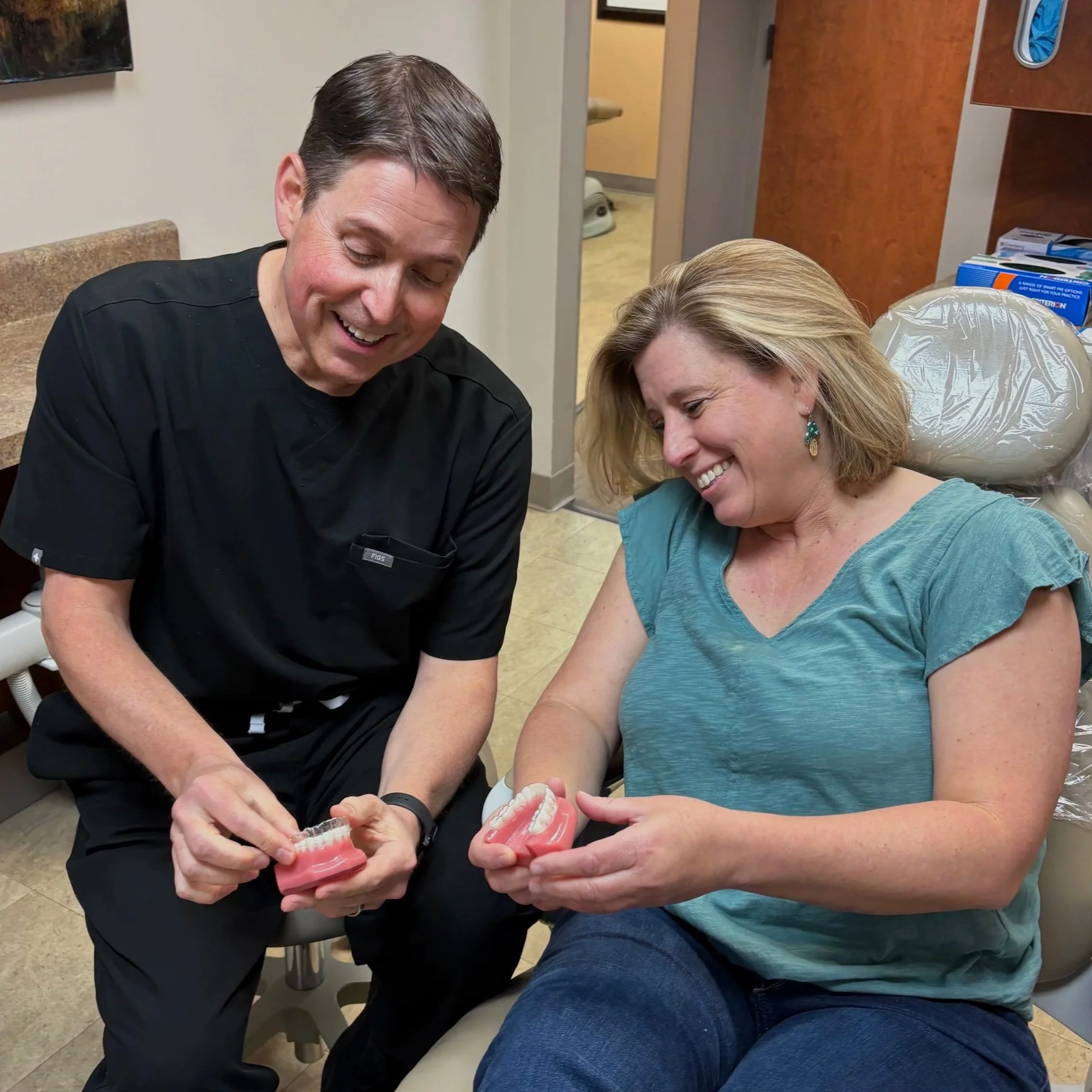 Dr. Ryan Haldeman orthodontist showing treatment options to adult patient at Upwards Orthodontics Flat Rock NC