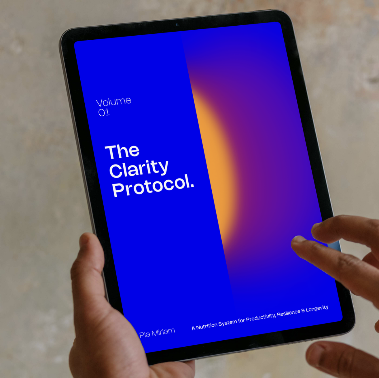 A person holding a tablet with the book cover titled "The Clarity Protocol." by Pia Miriam, showing a blue background with a colorful gradient on the right and text about a nutrition system for productivity, resilience, and longevity.
