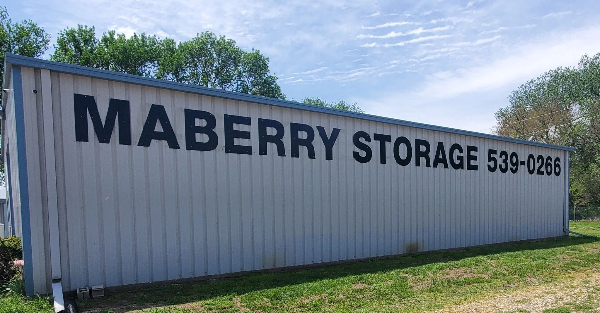 After photo — blue seamless gutter installation completed on Maberry Storage commercial building, Kansas — Gutter Solution LLC