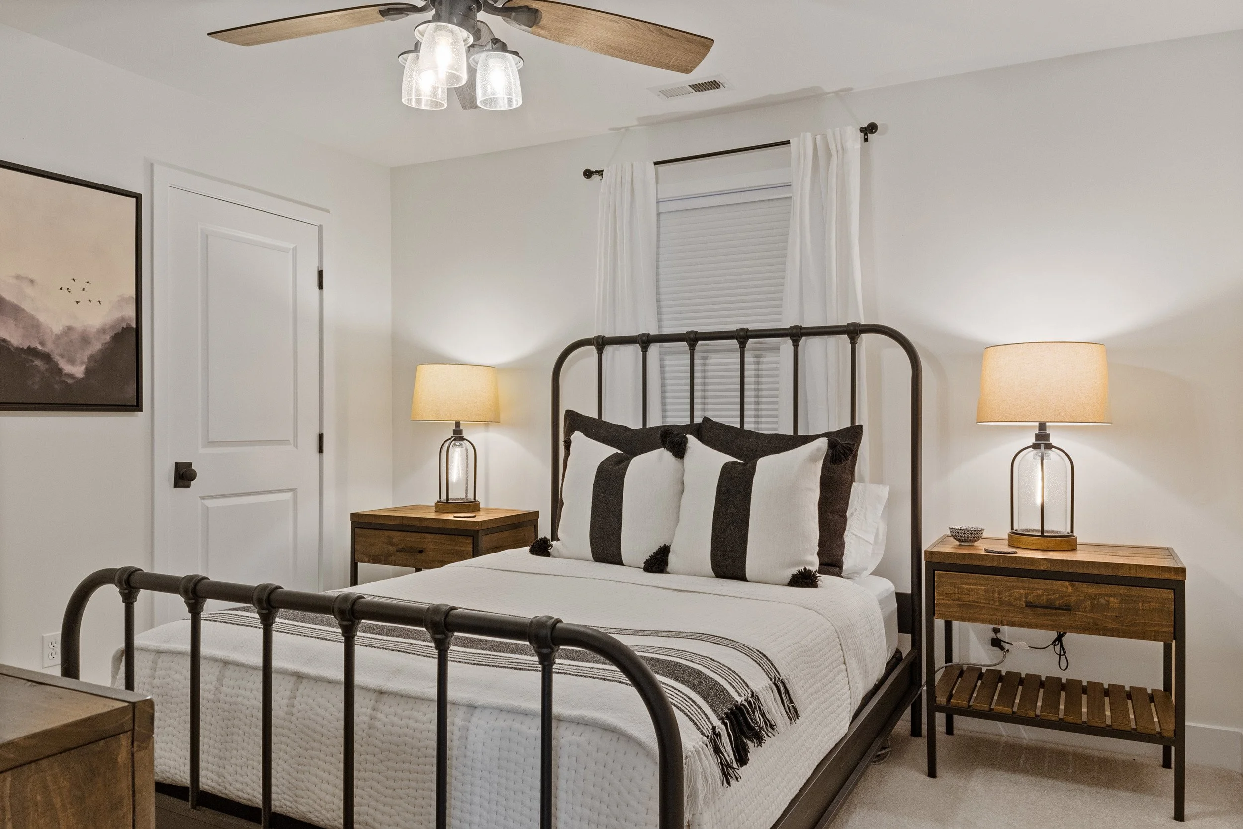 Guest bedroom with gueen iron bed and TV.jpg