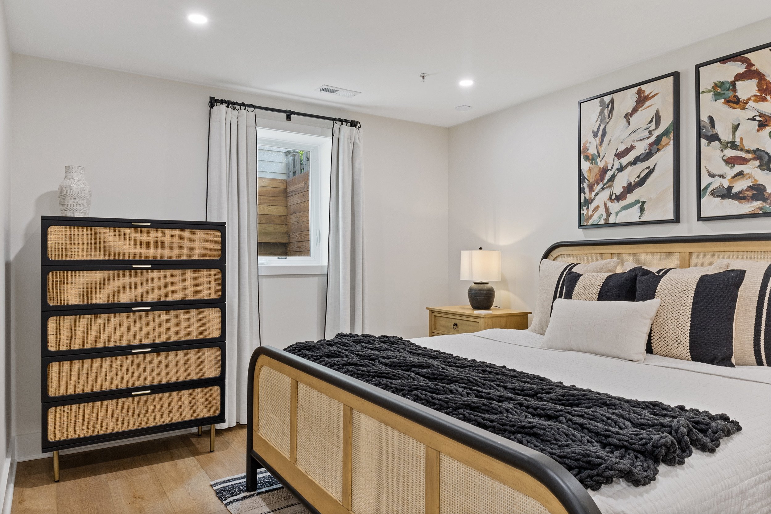 Basement bedroom with storage and black out curtains.jpg