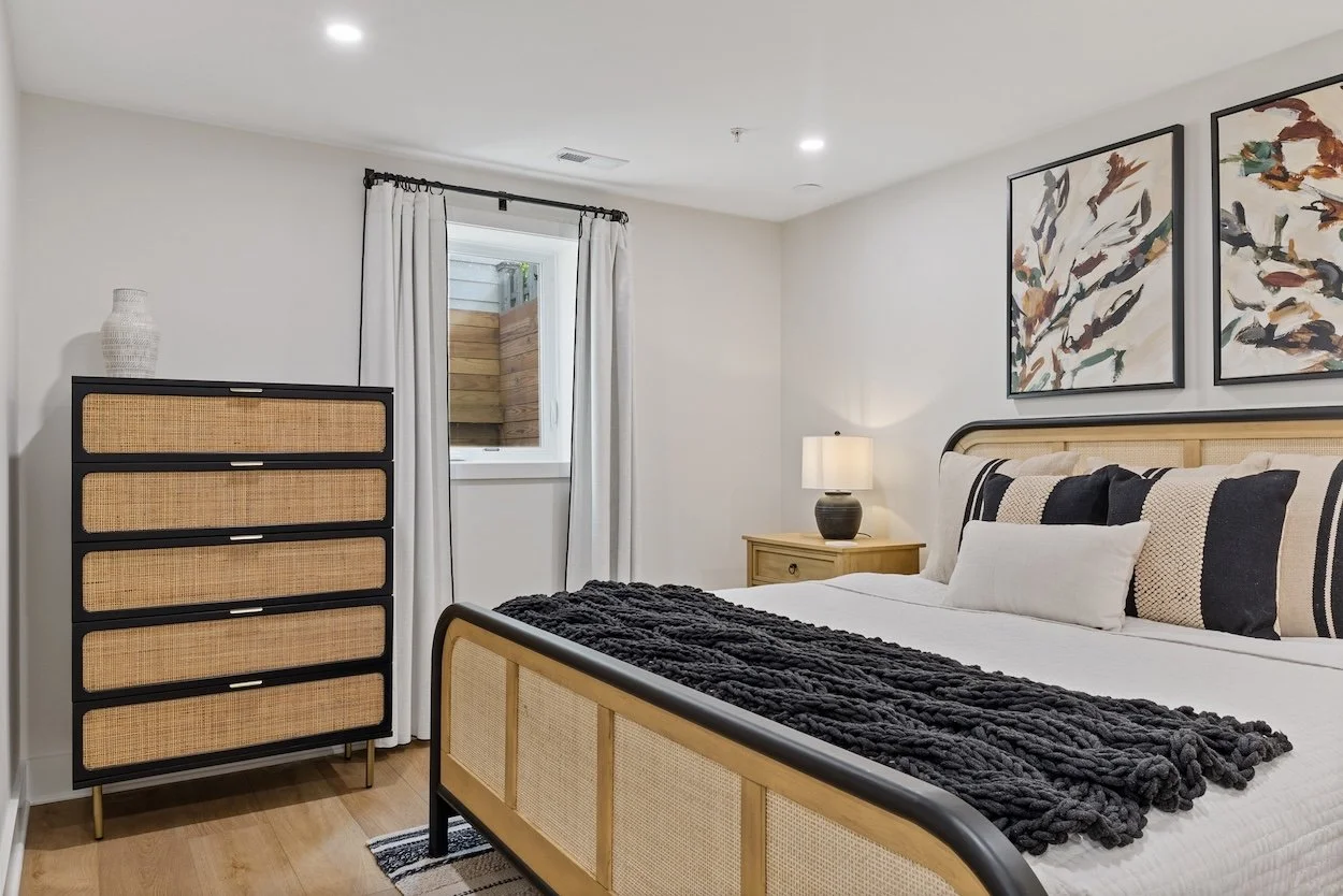 Basement bedroom with storage and black out curtains.jpg
