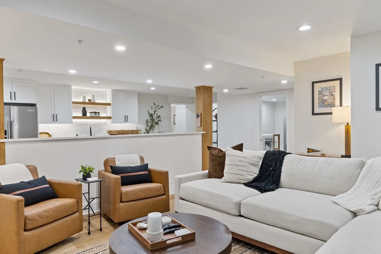 Basement sectional and leather swivel chairs.jpg