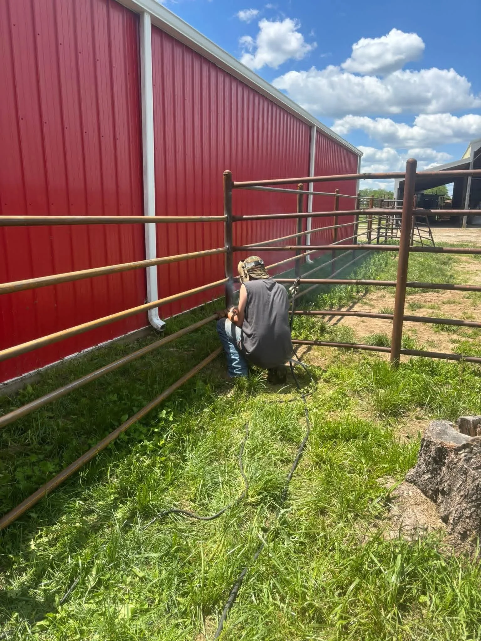 Owner welding original pipe fencing.