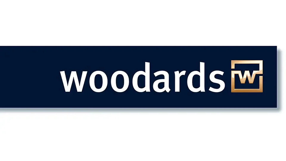 Woodards logo with the word 'woodards' in white text on a dark blue background and a stylized 'W' in a gold-colored frame.