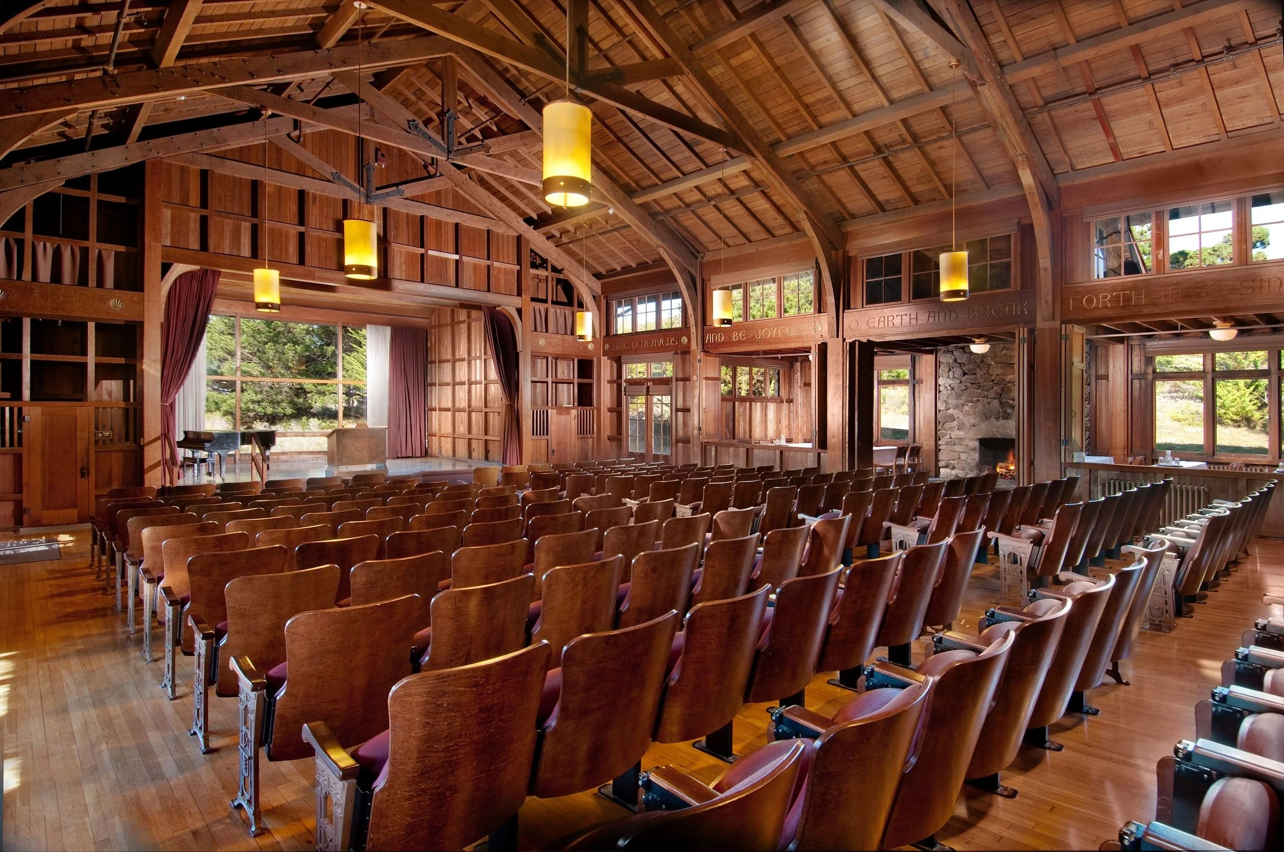 rustic-wooden-auditorium-with-rows-of-brown-seats-facing-asilomar-hotel-and-conference-grounds-pacific-grove-california.jpg