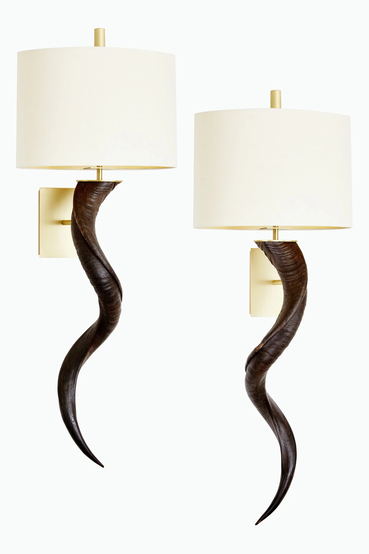 Two wall-mounted lamps with dark, curved wood bases and large white fabric lampshades.