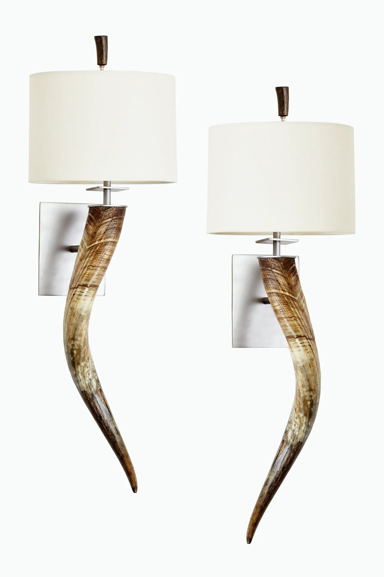 Two wall-mounted lamps with white shades and wooden curved bases.