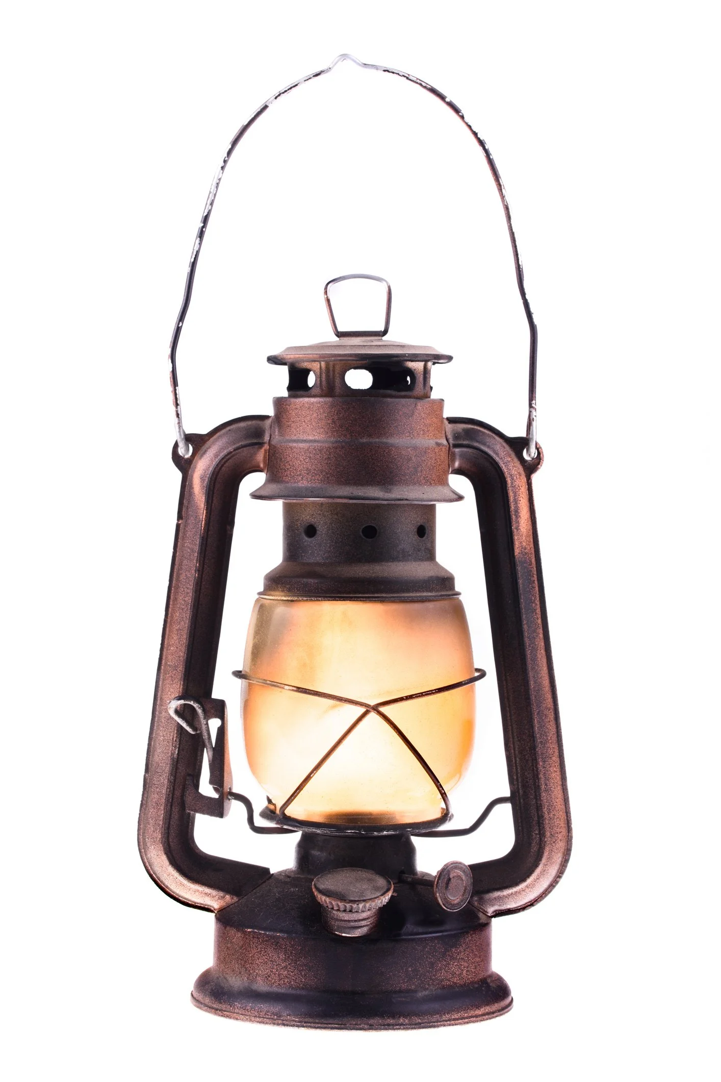 An old, rusty kerosene lantern with a glowing yellow-orange light, metal frame, and handle at the top.