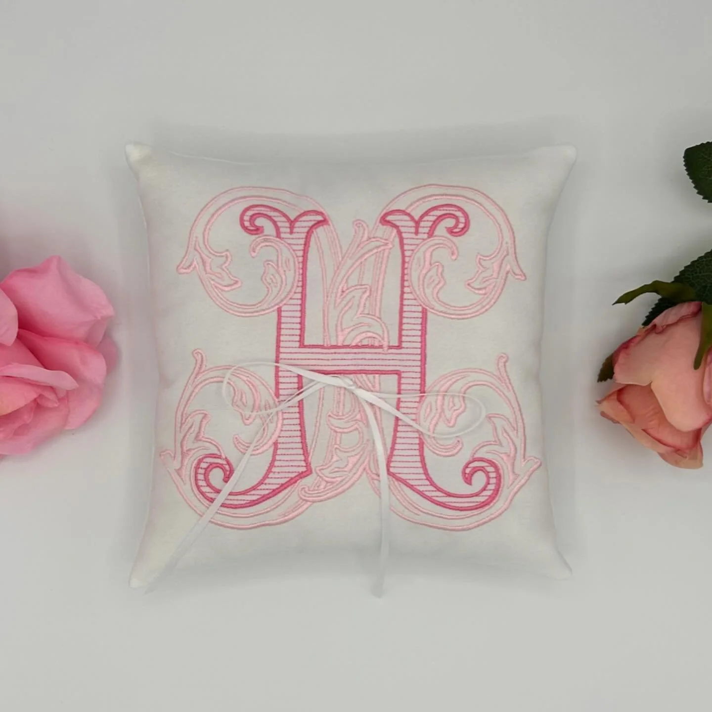 Customize an embroidered monogram ring pillow that will be treasured long after the wedding day ✨🩷 Explore more designs on our Etsy shop at sewingsistersapparel #embroidery #wedding #etsy #smallbusiness #custom