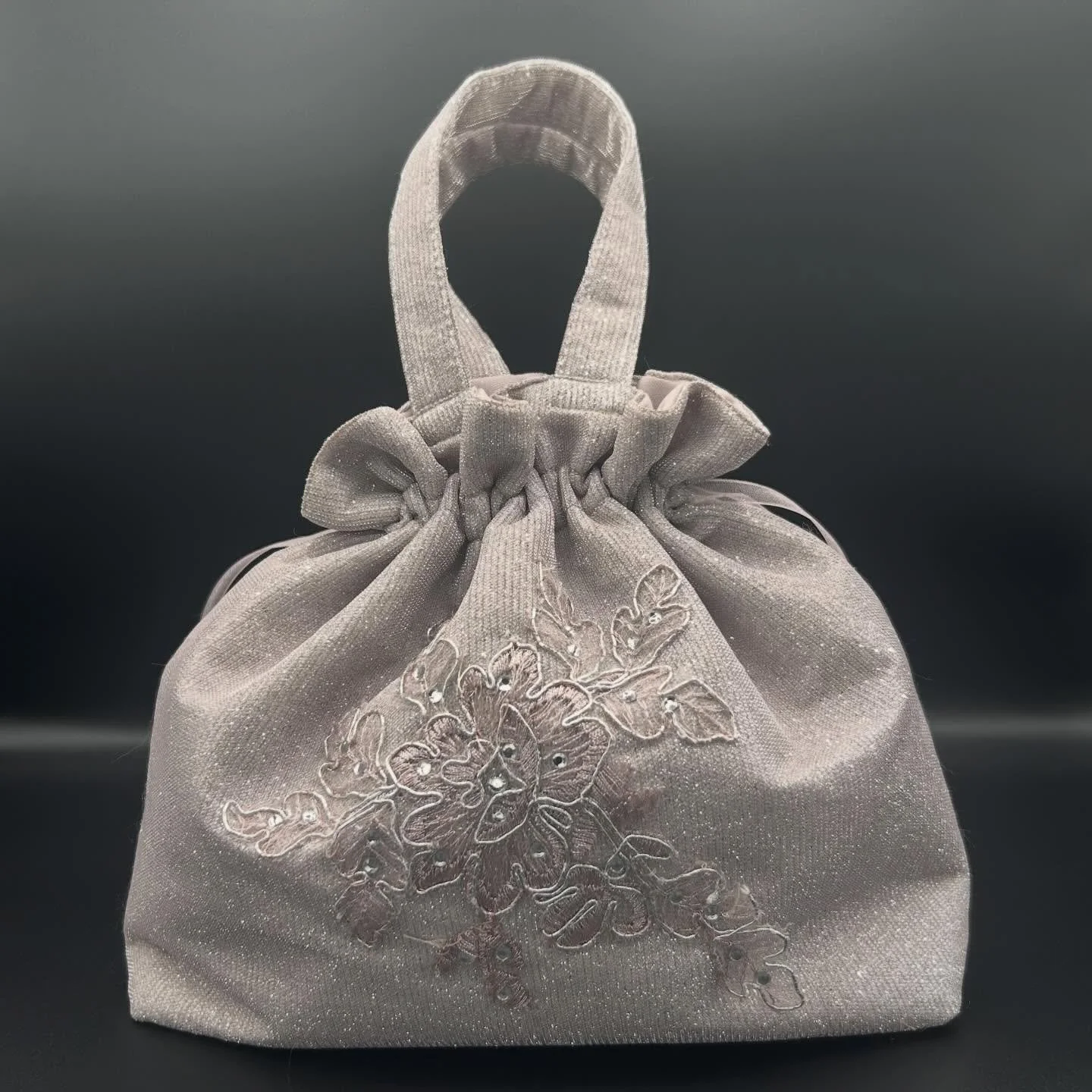 An embroidered drawstring bag with handles ✨ every bag we create is personalized and crafted by hand. An heirloom&mdash;turning a grandmother&rsquo;s dress into the cutest drawstring bag #embroidery #custom #repurposed #womenowned #smallbusiness