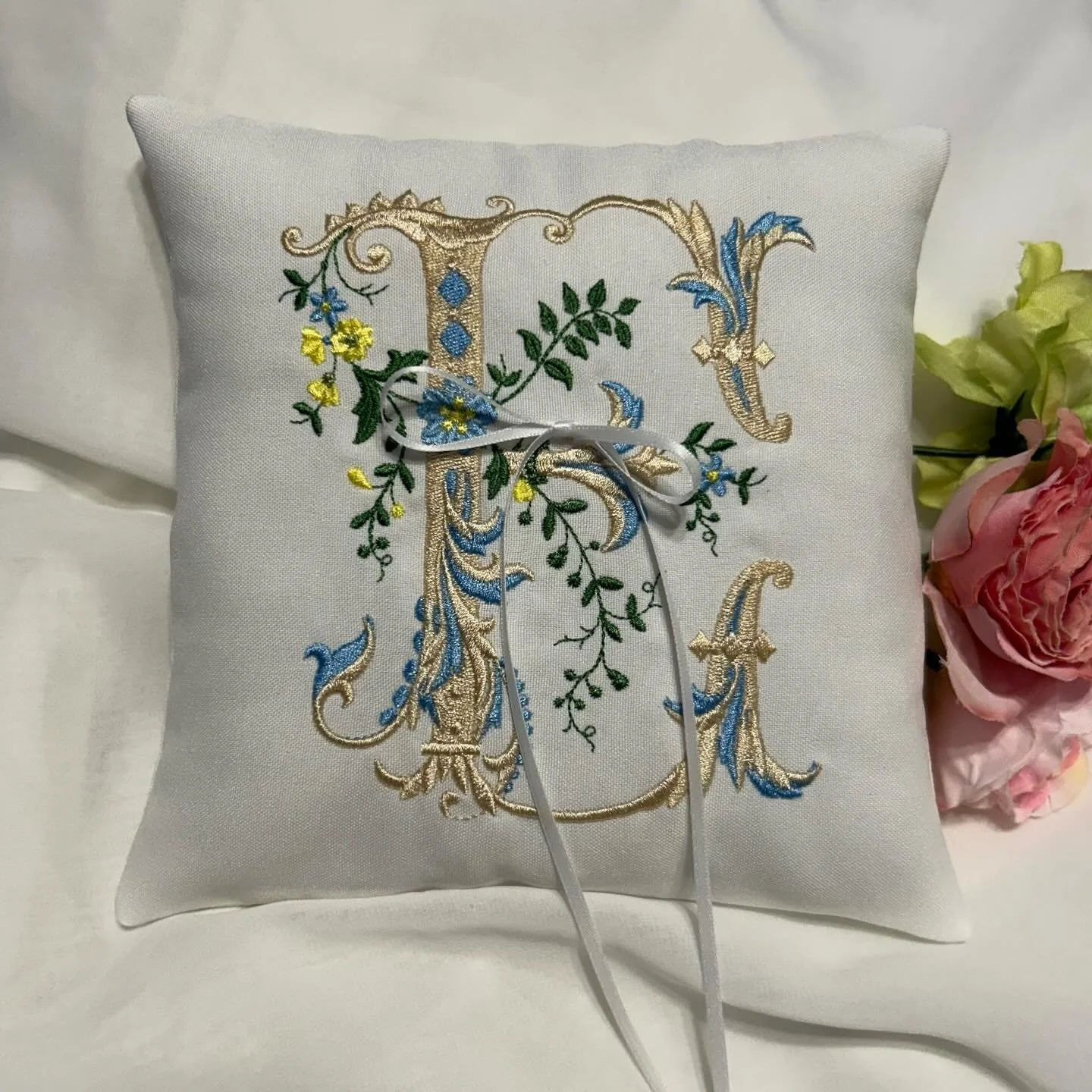Choose your custom colors on this beautiful Victorian monogram to create a one-of-a-kind heirloom. Choose the accent for the initial and select two colors for the flowers for a beautifully unique ring bearer pillow. Shop our embroidery on our website