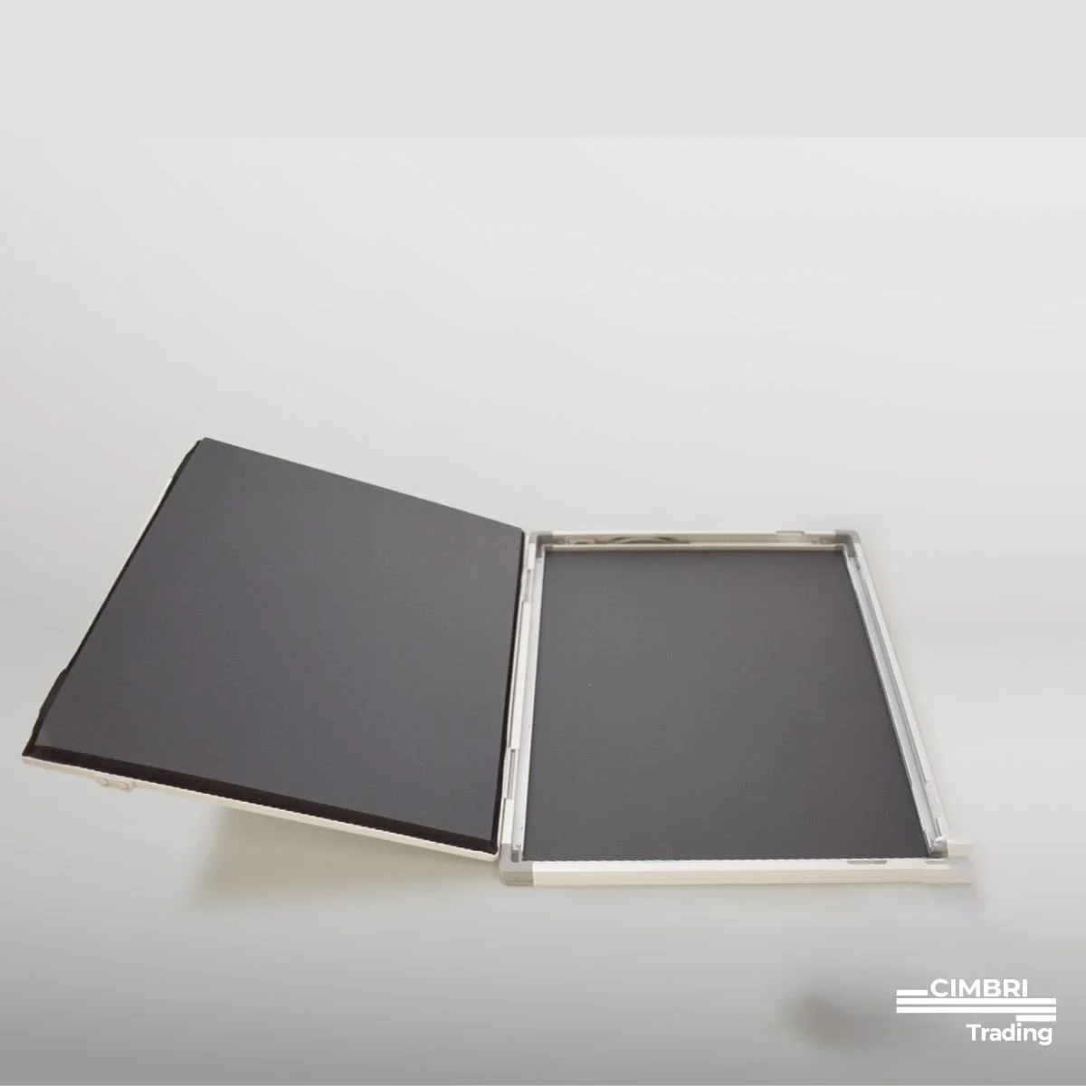 An open black and silver photo lightbox with a black surface inside, placed on a white background.