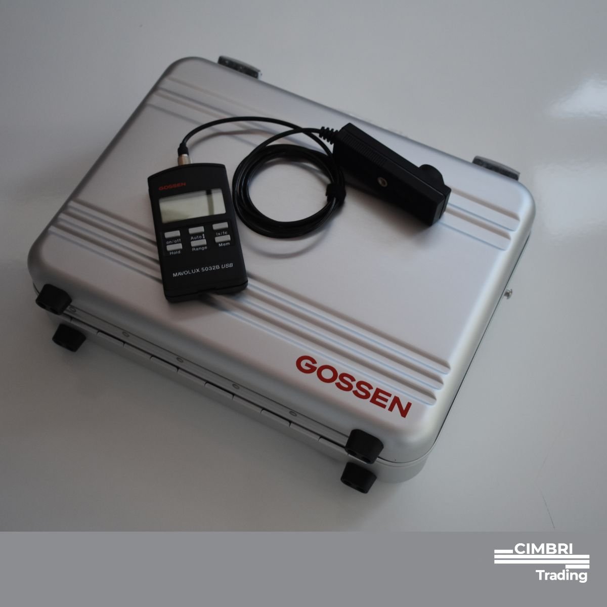 Aluminum carrying case labeled GOSSEN with a digital light meter and sensor placed on top.