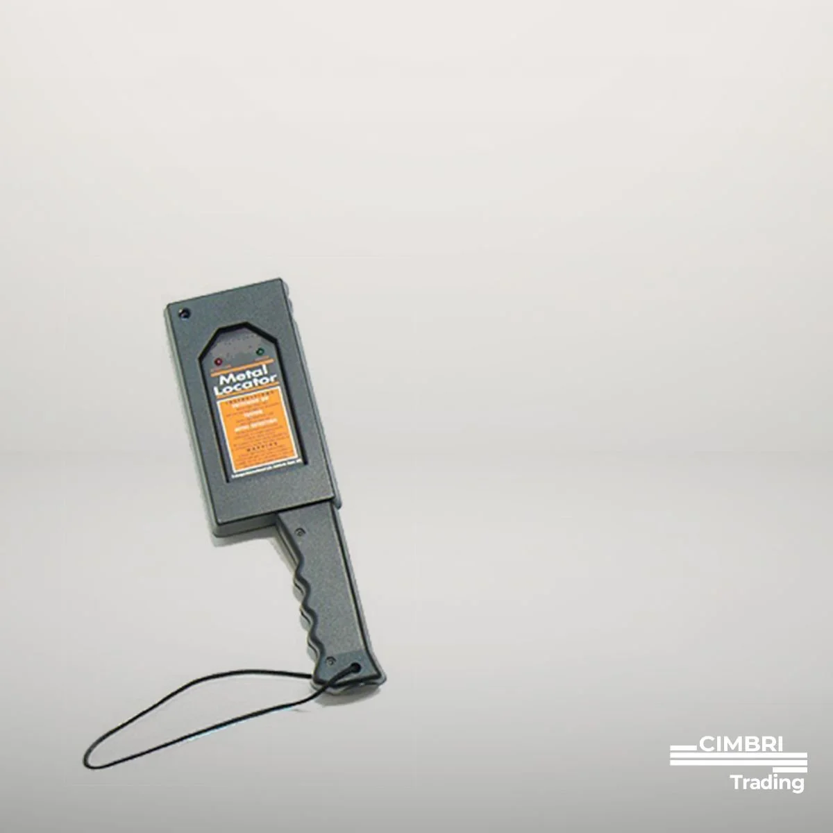 A metal locator device with a screen and a handle, placed on a white surface. The device has a wire attached to its bottom, and it displays the words 'Metal Locator' on the screen.