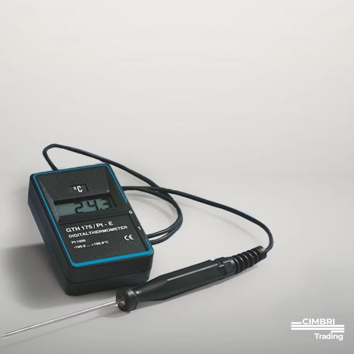 A digital thermometer and a probe thermometer on a white surface, with the display showing 24.3°C, used for measuring temperature.