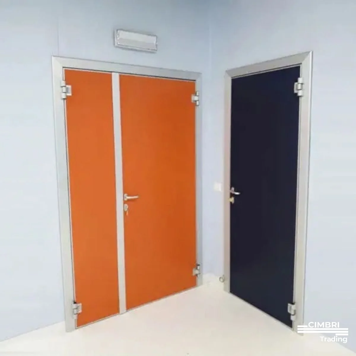 Two closed doors in a room, one with orange panels and the other with dark panels, both with silver frames and handles.