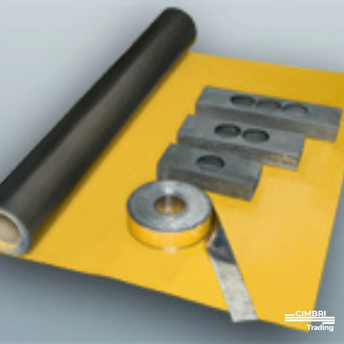 Metal shaft, washers, and metal spacers on a yellow surface used for industrial or mechanical purposes.