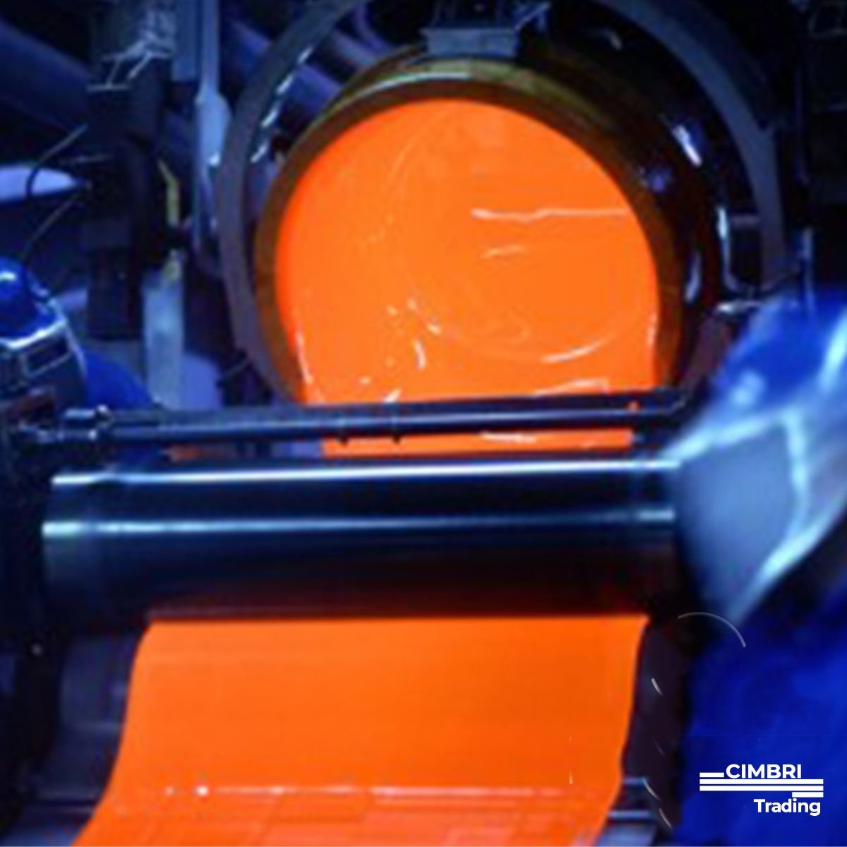 A glowing orange molten metal being poured from a furnace into a mold in a manufacturing setting.