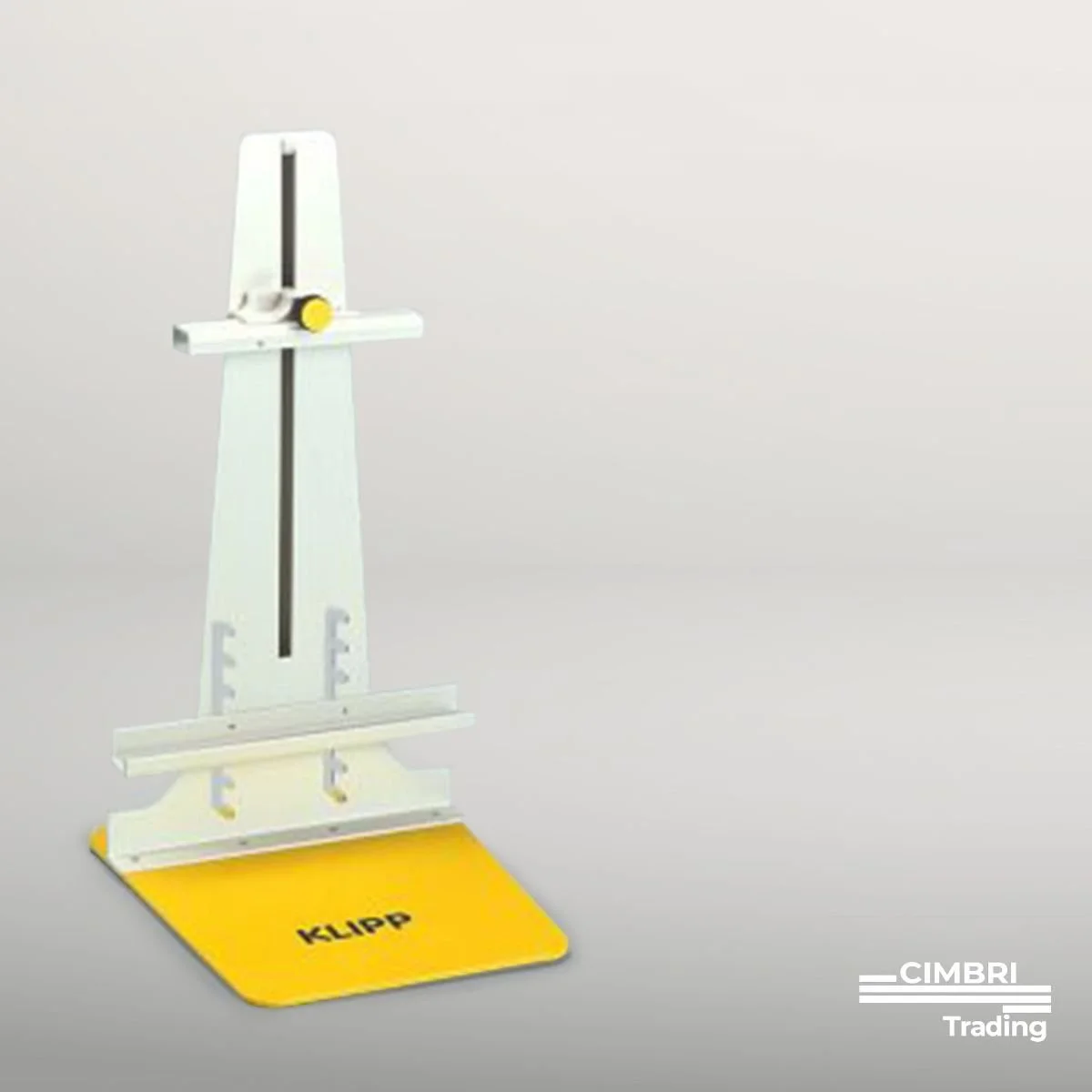 A white and yellow manual measuring instrument with the word 'KLIPP' written on a yellow base, placed against a plain light gray background.