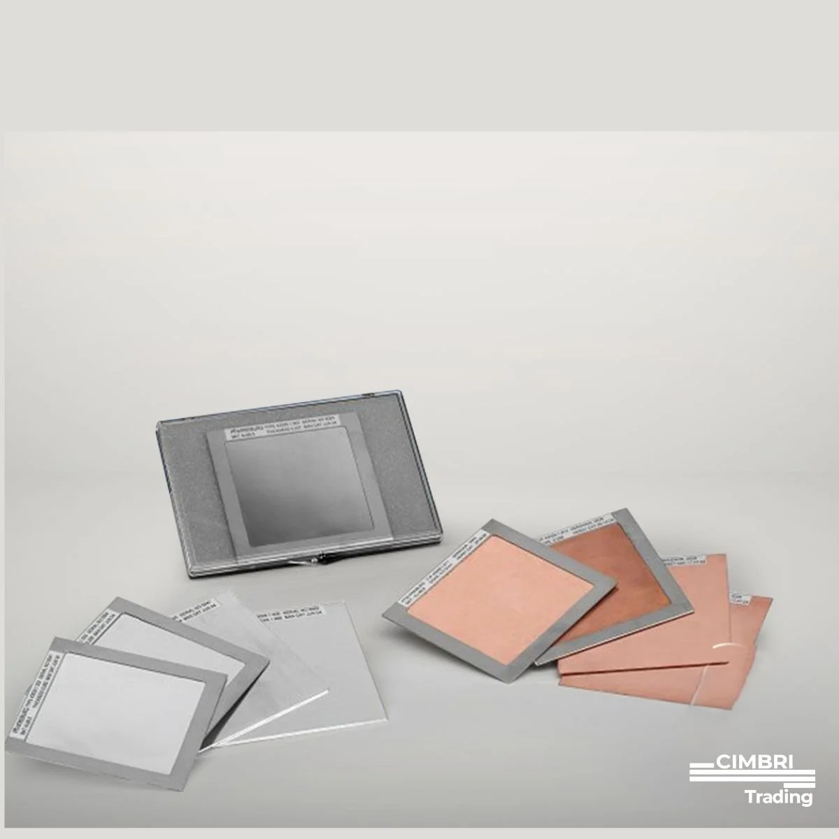 Several color samples and swatches, including white, tan, and copper, displayed on a white surface, with a gray case containing a sample card or palette, and the word 'CIMBRI Trading' in the bottom right corner.