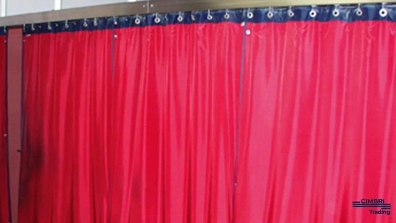 A red curtain with metal grommets hanging from a top rail, with a small logo reading 'CIMBRI Trading' in the bottom right corner.