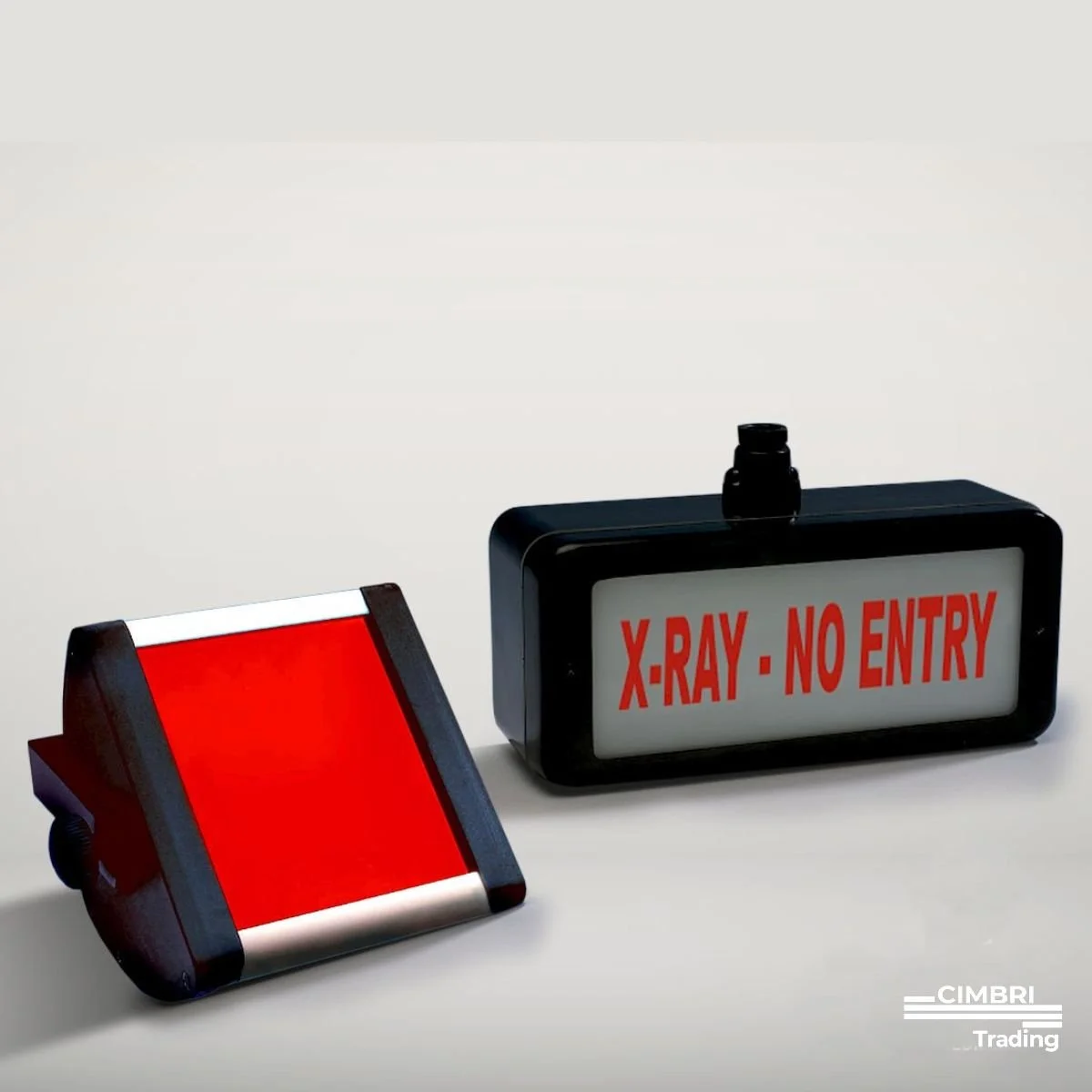 Two electronic signs, one with a red blank display and the other with a white display that reads 'X-RAY - NO ENTRY,' are placed on a white surface against a plain white background.