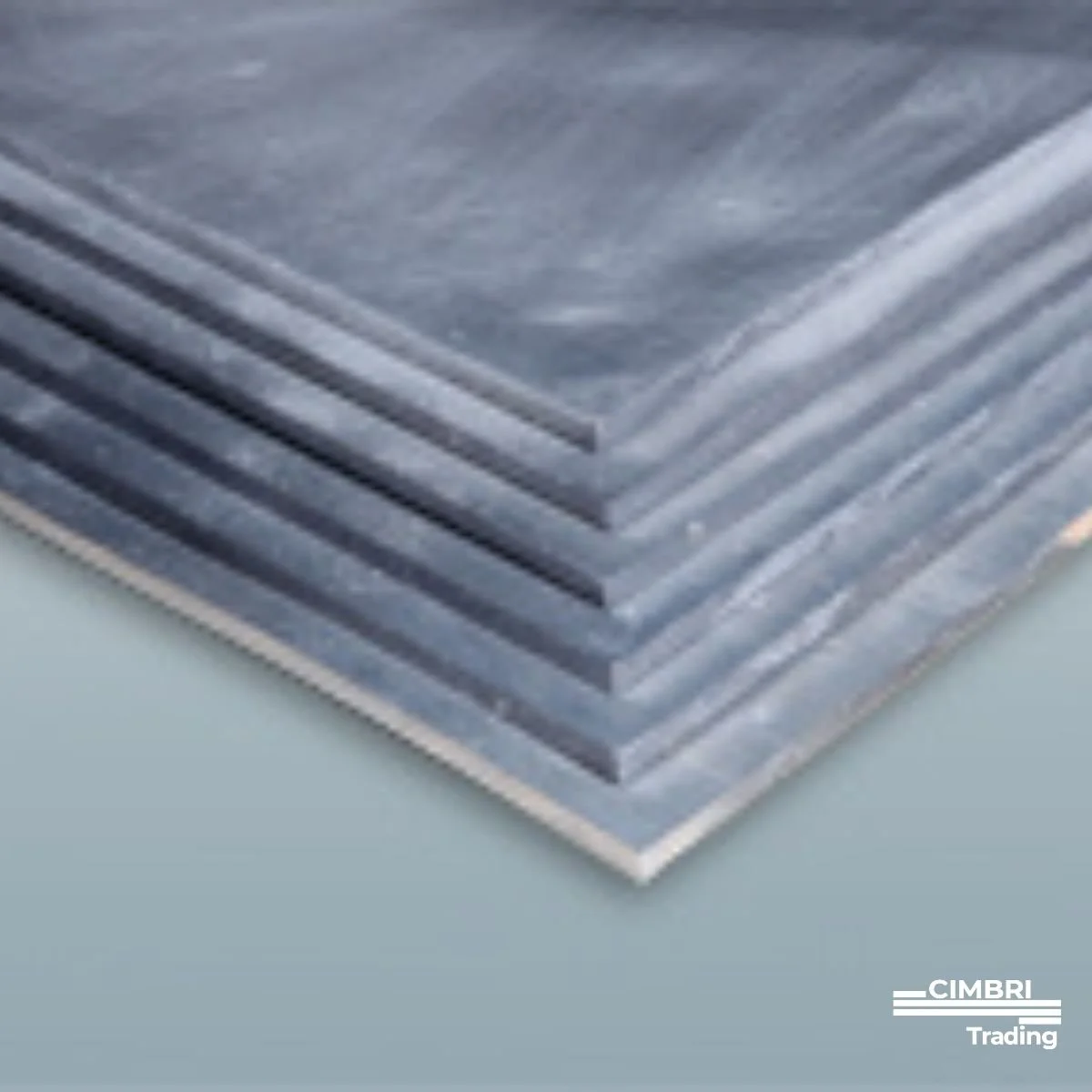 Close-up of several gray metal sheets stacked together.