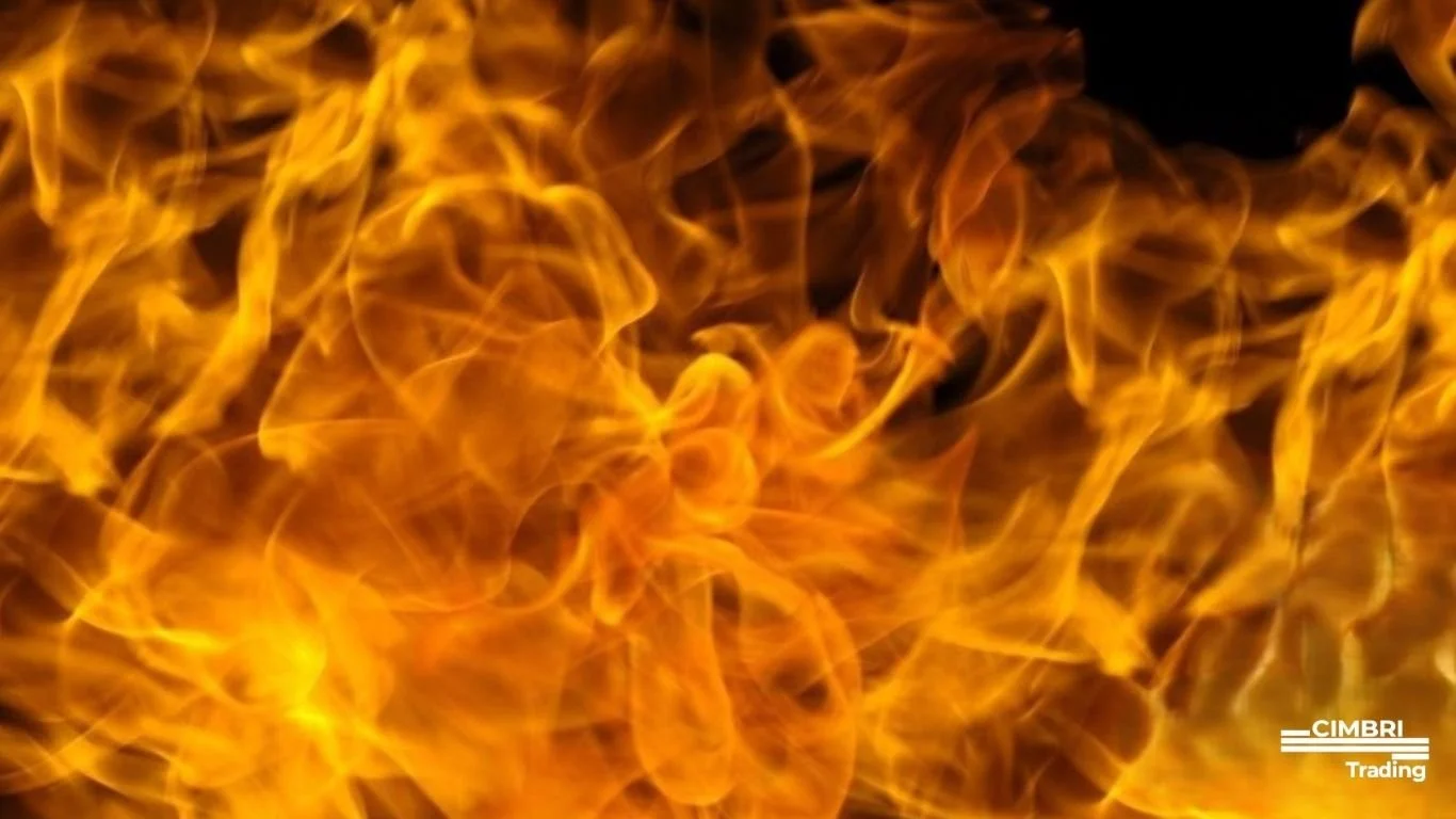 Close-up of bright orange and yellow flames with black background and white text reading 'CIMBRI Trading' at the bottom right corner.