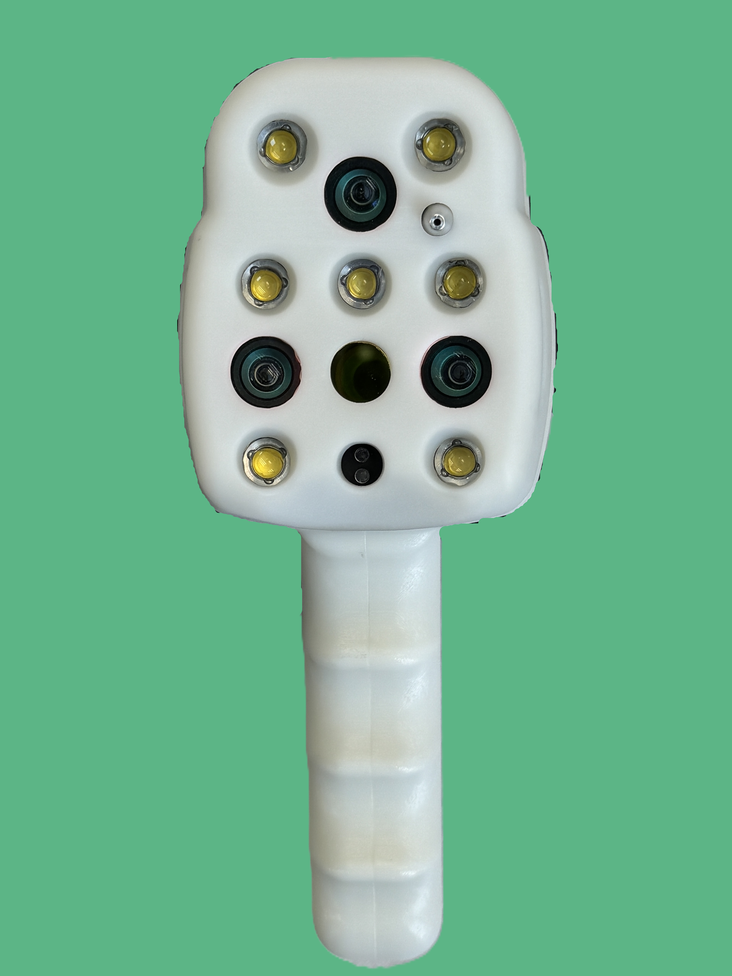 A medical device with multiple sensors, circular lenses, and LED lights mounted on a white handle against a green background.