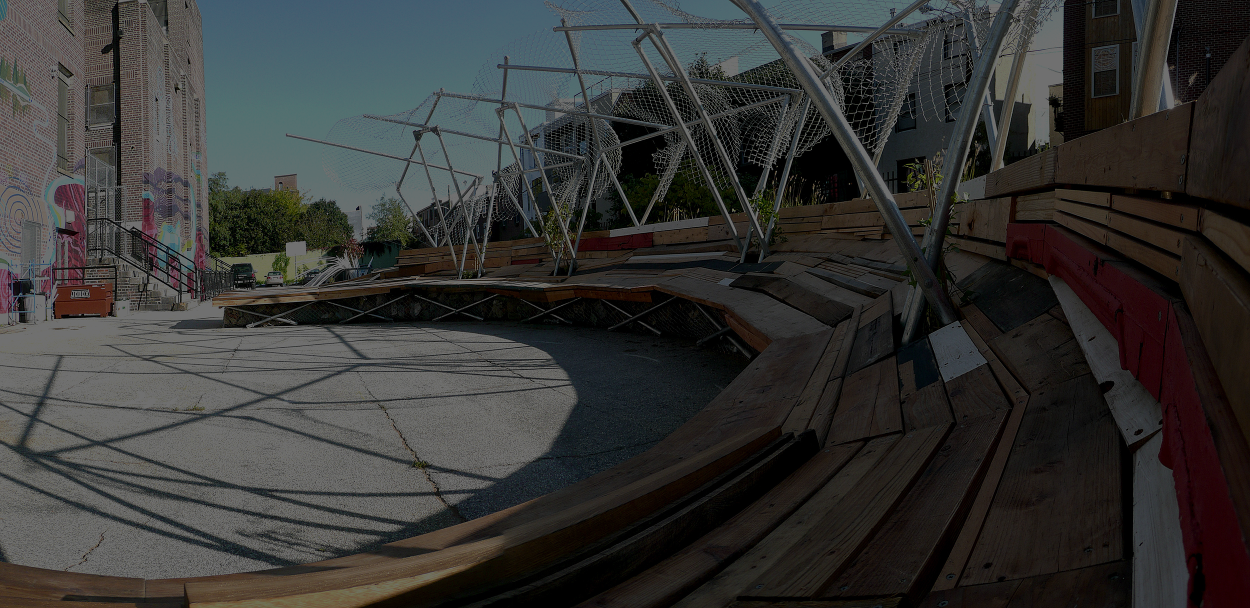 communal area made of chainlink fence and reclaimed wood outside
