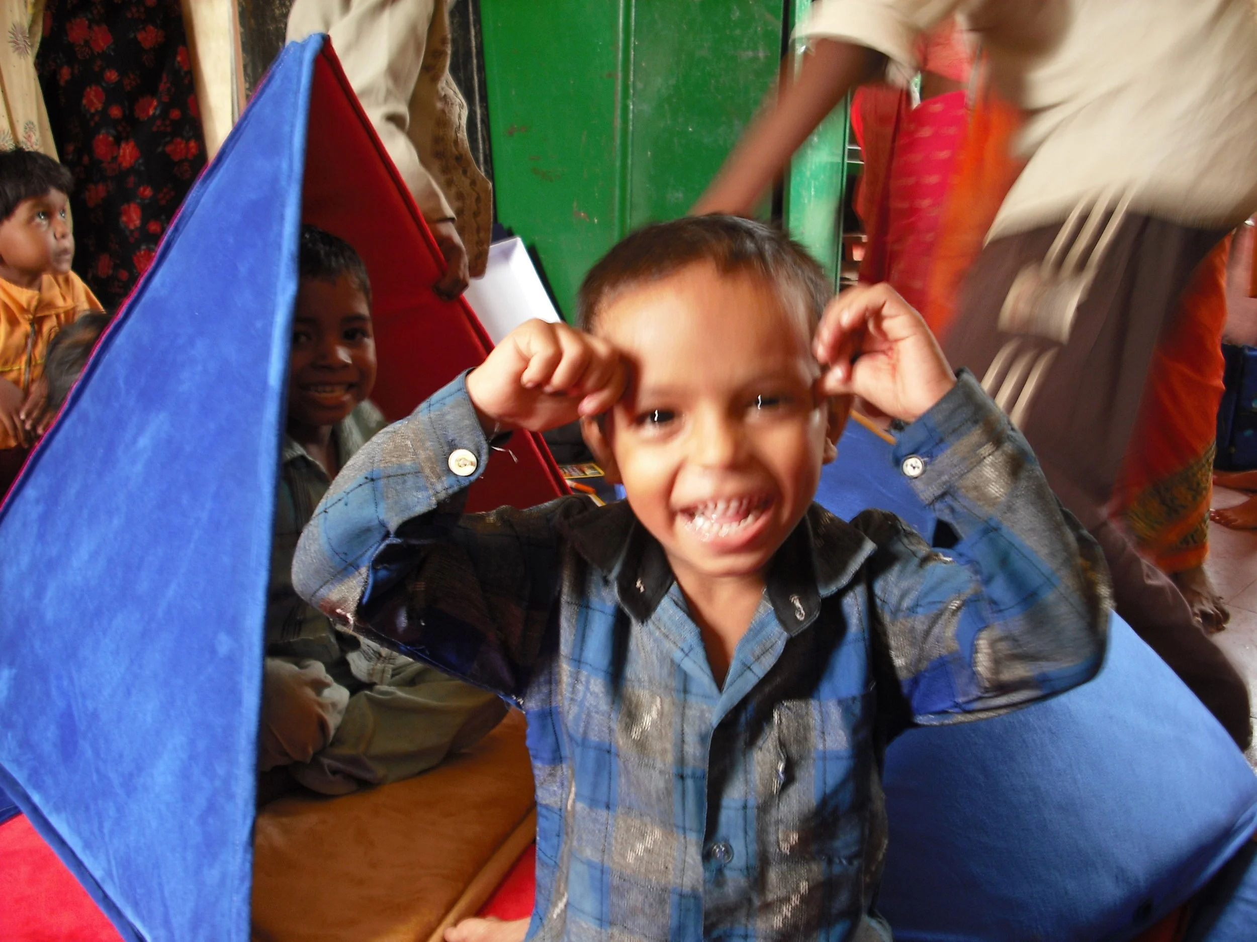 School students smiling with classroom materials