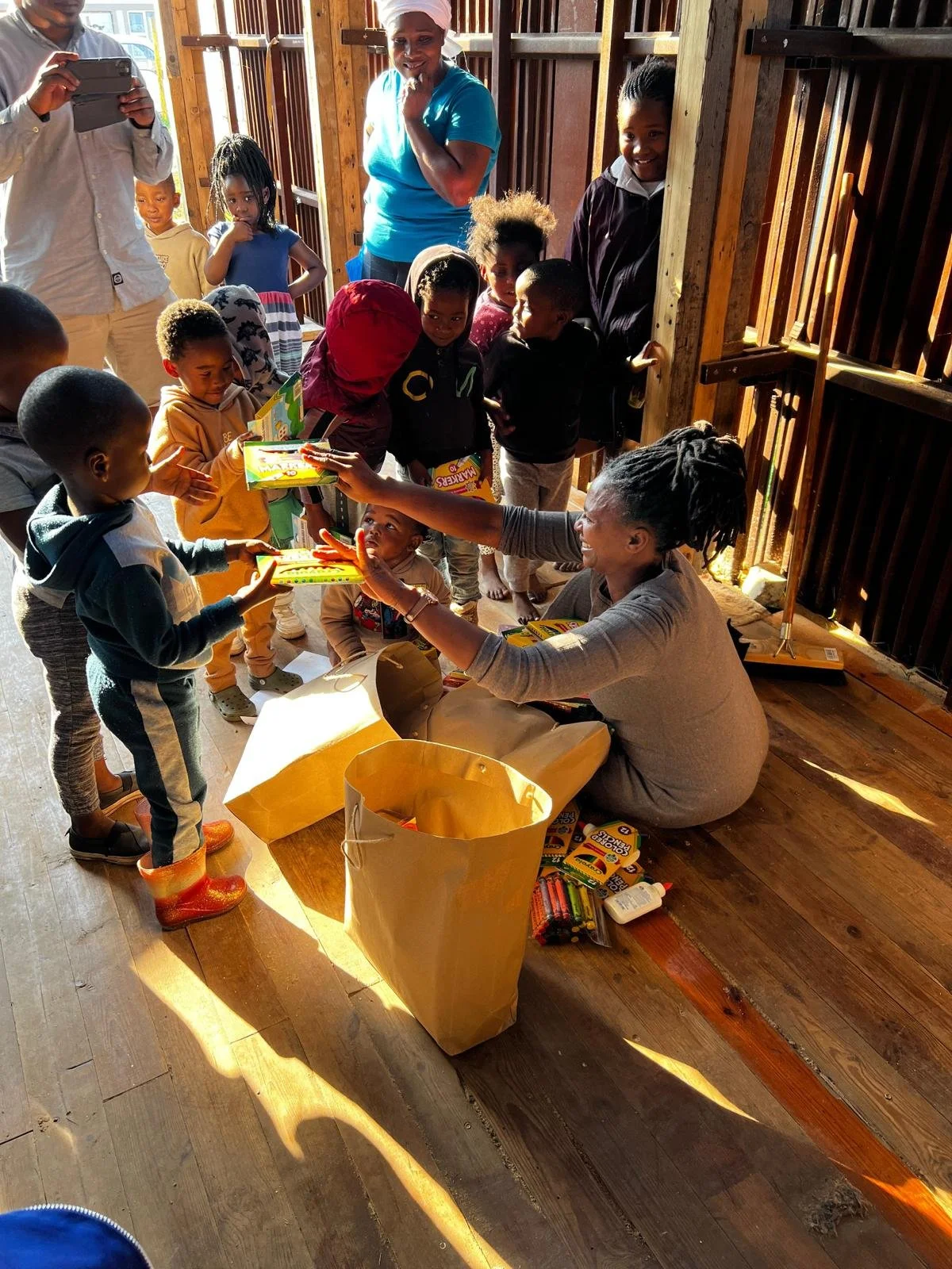 Volunteer with students in the Penguin Play and Learn Educational Center