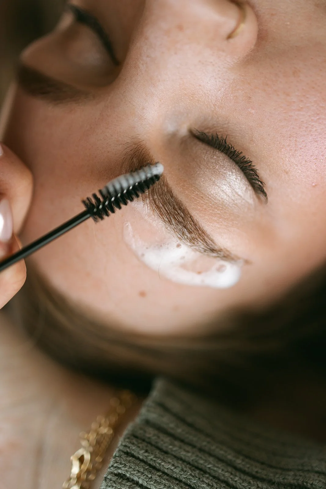 Facial treatment performed by an esthetician at Symmetrie Studios