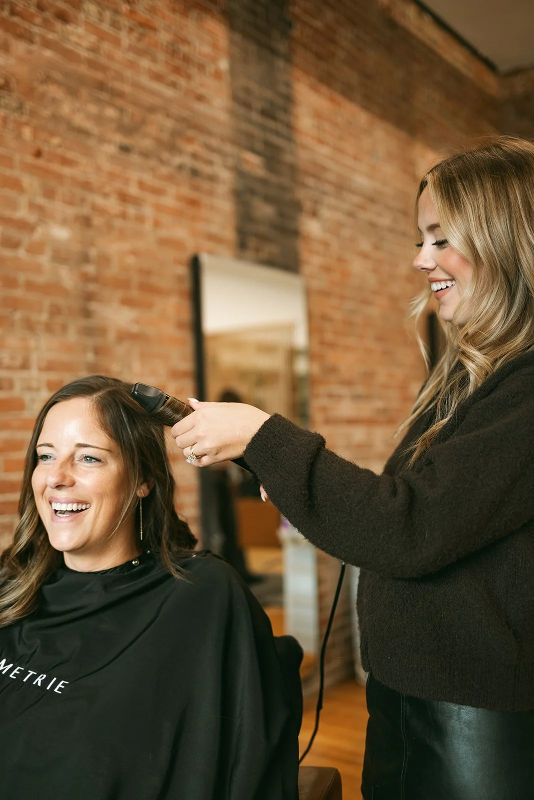 Dimensional brunette hair color created by a Symmetrie Studios hairstylist