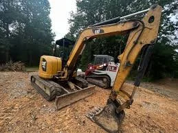 Yellow excavator with a bucket attachment on a construction site