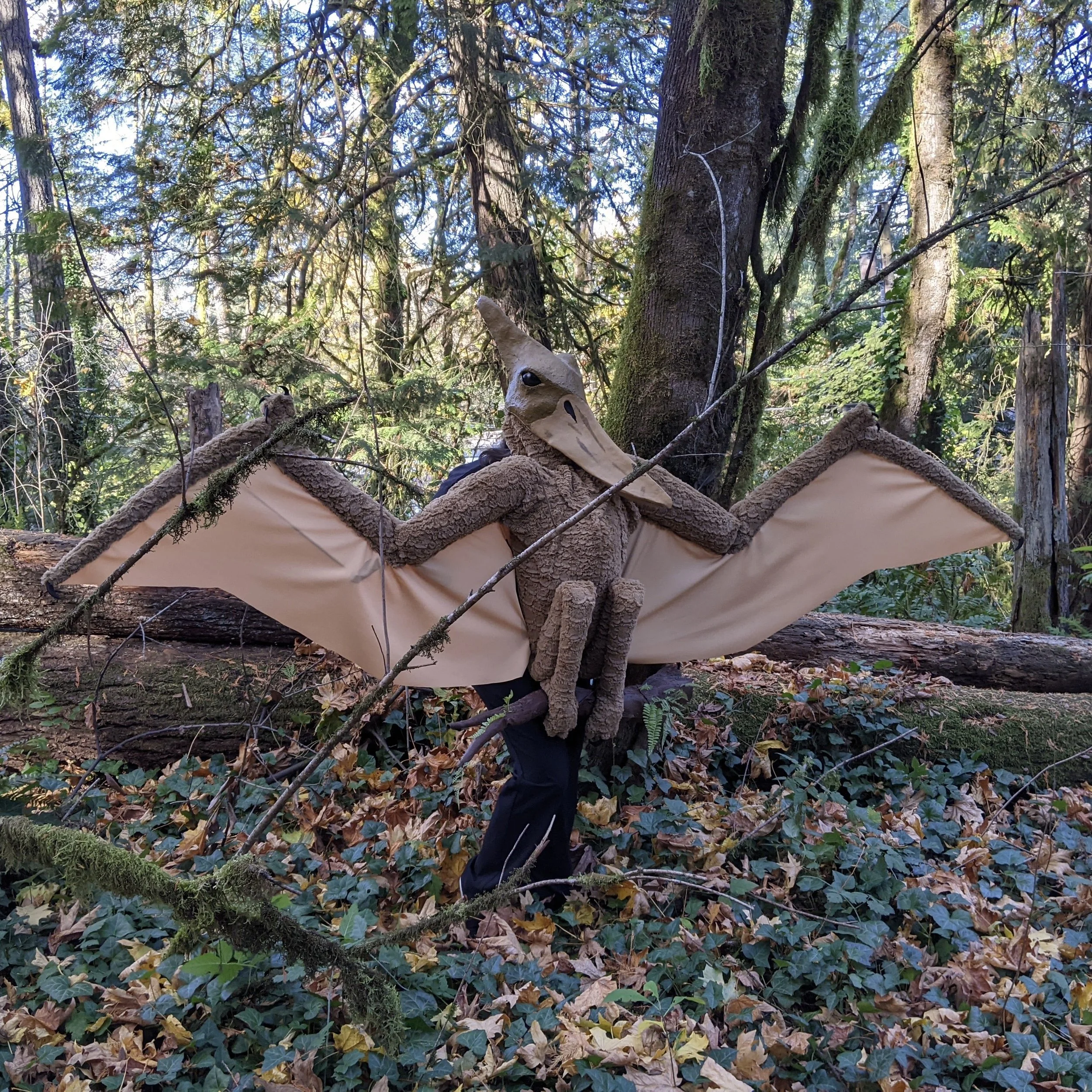 Person in a pterodactyl costume in the woods