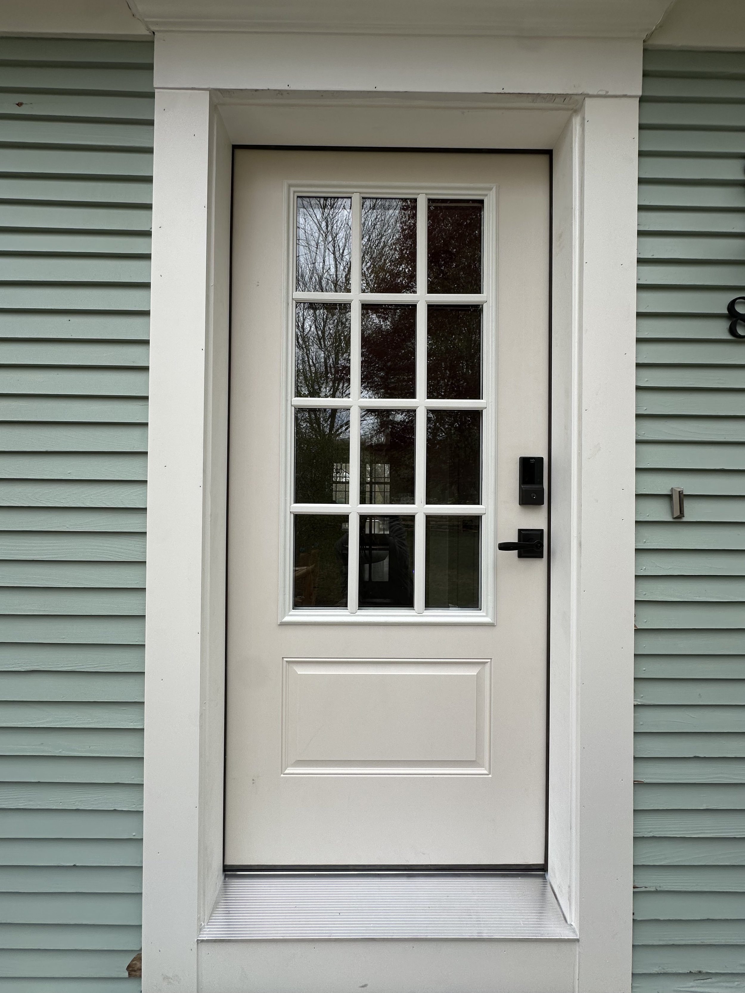 Exterior view of a door with a glass windowpane.
