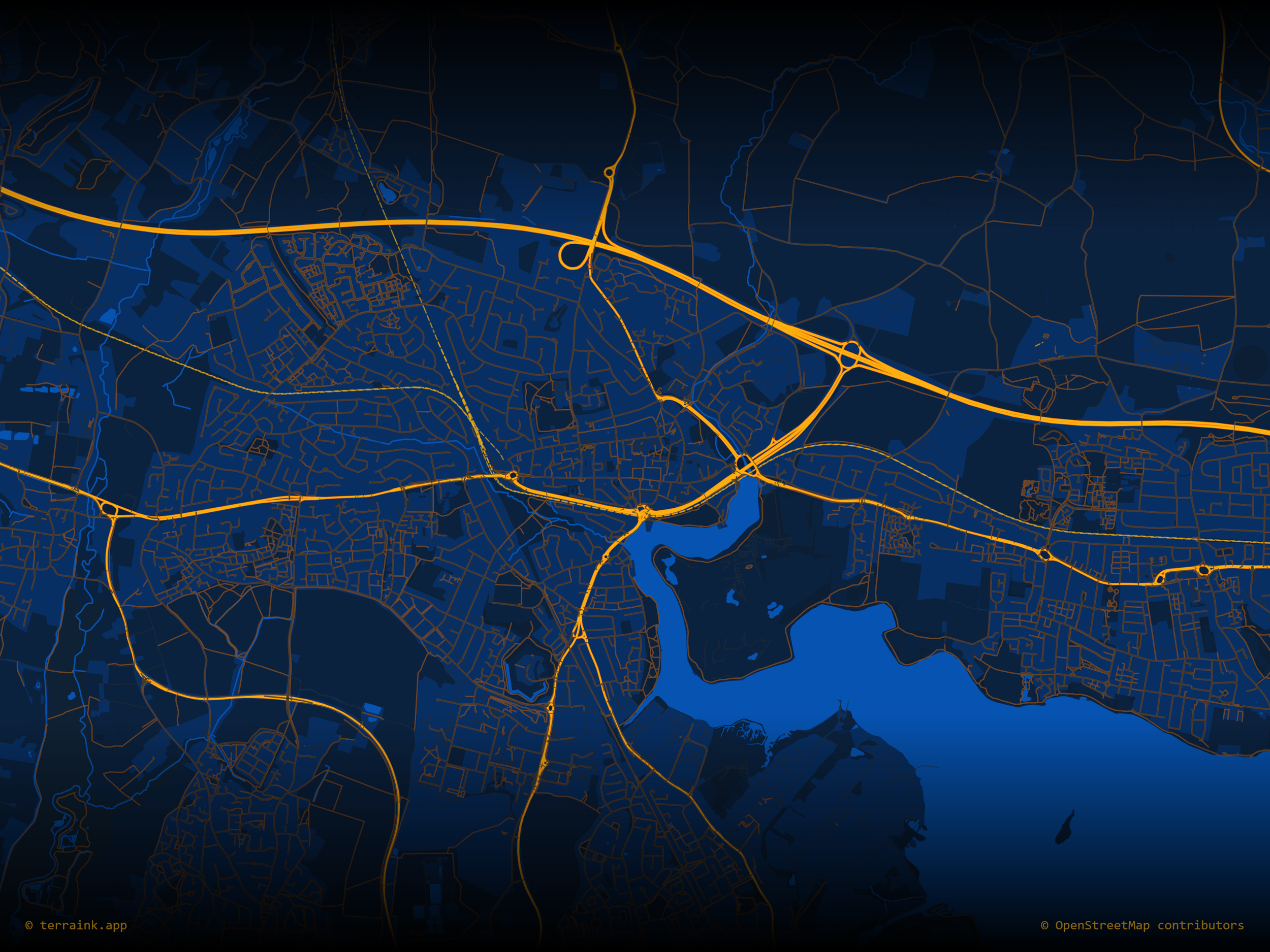 Nighttime map view of a city showing roads highlighted in yellow, with water bodies and neighborhoods in dark blue and black, including highway interchange and surrounding area.