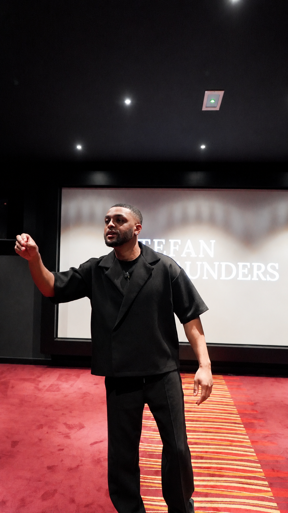 Stefan Saunders Speaking on Stage during a Keynote Talk
